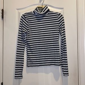 Cute turtle neck top. Perfect for under sweater vests or baggy t shirts